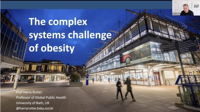 A presentation slide titled "The complex systems challenge of obesity" is displayed, with Prof Harry Rutter visible in a small video call window.