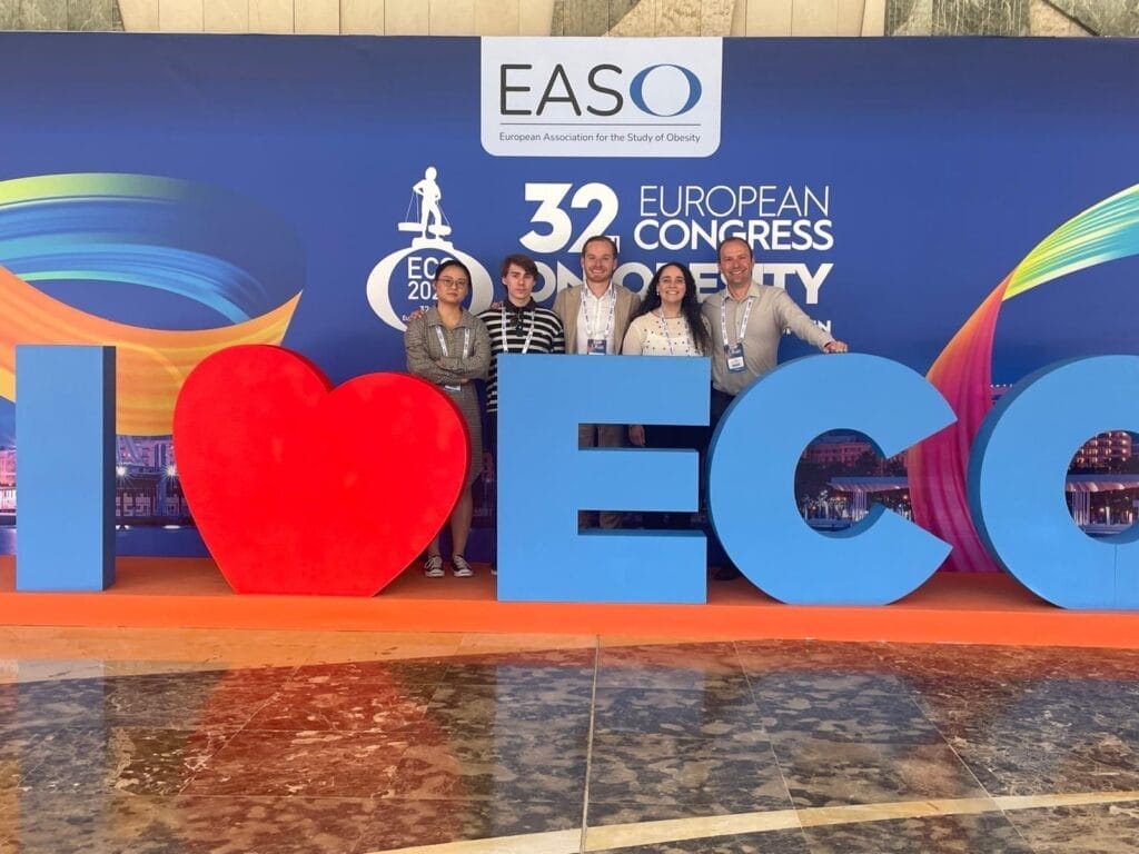 Five people stand behind large letters spelling "I ♥ ECO" at the 32nd European Congress on Obesity, with the EASO logo displayed on the backdrop.